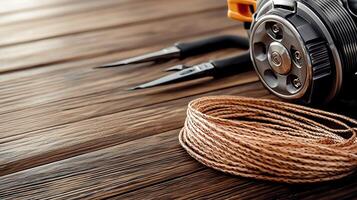 Close-up of a spool of twine and tools on a wooden surface, showcasing craftsmanship and detail photo