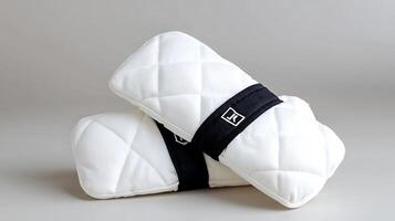 Two white quilted pillows stacked on a neutral background, showcasing their soft texture and design photo