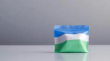 Colorful packaging of a product displayed on a smooth surface with a minimalistic background photo