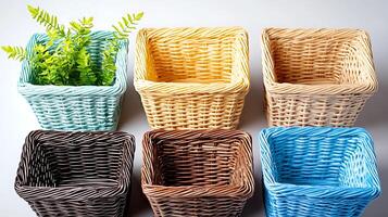 Colorful wicker baskets arranged in a grid with a green plant in one, set on a clean surface photo
