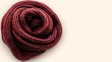A close-up view of a neatly coiled red rope on a soft beige background, ideal for crafts photo
