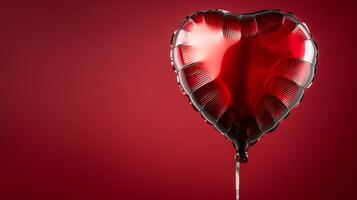 Shiny red heart-shaped balloon floating against a deep red background, evoking love and celebration photo