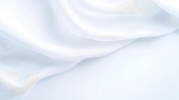 Soft white silk fabric draping gracefully, creating elegant folds and shadows, ideal for backgrounds photo