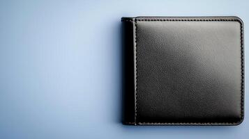 A sleek black wallet resting on a soft blue surface, showcasing its minimalist design and elegance photo