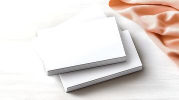 Stacked blank business cards on a light wooden surface with a soft fabric drape in the background photo