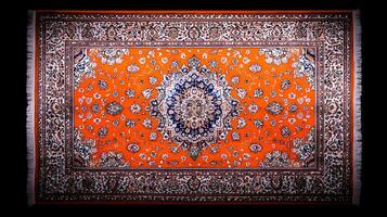 Vibrant orange Persian carpet featuring intricate floral patterns, displayed on a dark background photo