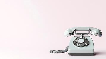 Vintage rotary phone on a soft pink background, evoking nostalgia and simplicity in design photo