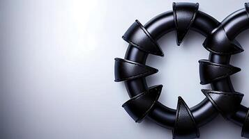 Close-up of black circular objects with pointed edges on a smooth gradient background photo