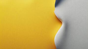 Close-up of a yellow and gray paper surface with a smooth curve, creating a minimalist design photo