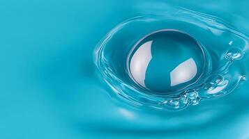 Close-up of a water droplet creating ripples on a turquoise surface, showcasing fluid dynamics photo