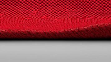 Close-up of a vibrant red textured fabric showcasing intricate weave patterns against a neutral background photo