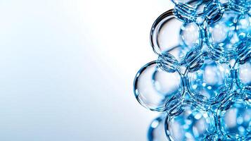 Close-up of translucent blue bubbles clustered together against a soft gradient background photo