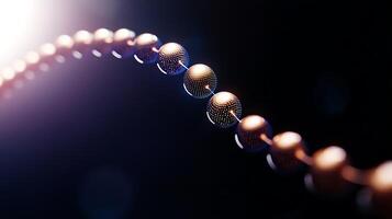 Close-up view of a series of metallic spheres connected by a thin line against a dark background photo