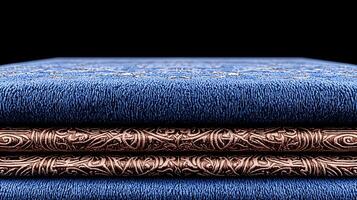 Close-up view of intricately designed blue fabric stacked with ornate copper accents, showcasing texture photo