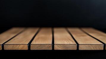 Close-up view of a wooden tabletop with distinct grain patterns set against a dark background photo