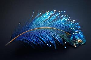 Glittering blue feather creating a trail of sparkling light on dark background photo