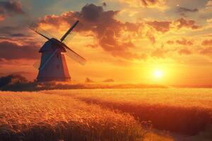Traditional windmill standing in golden wheat field at sunset photo