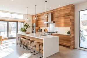 Modern open concept kitchen featuring island with bar stools and wood paneling photo