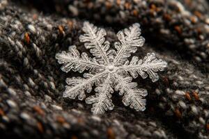 Real snowflake resting on knitted wool showing intricate structure photo