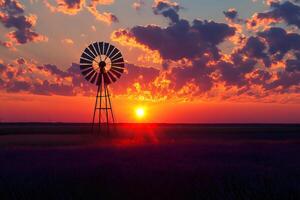 Multi blade windmill standing in lavender field at sunset with dramatic clouds photo