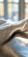 Soft texture of natural linen fabric illuminated by sunlight photo