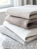 Linen fabric stacked in neutral tones for home decor photo