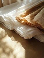 Textures of linen fabric displayed on a wooden table photo