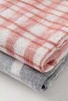 Linen fabric towels in red and gray colors stacked neatly photo