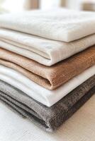 Linen fabric stack in neutral tones for home decor photo