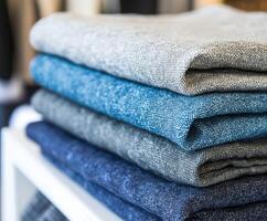 Variety of linen fabric stacked neatly for display photo