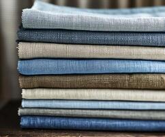 Collection of linen fabric in various colors stacked neatly photo