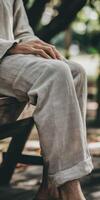 A man sitting on a bench with his legs crossed photo