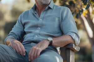 A man sitting on a bench in a park photo