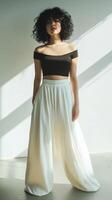 A woman in a crop top and wide pants photo