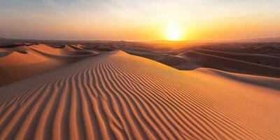 Sunset over rolling sand dunes in the desert landscape photo