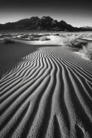 Black and white photograph of sand dunes in the desert photo