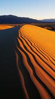 A desert with sand dunes and mountains in the background photo