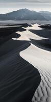 A desert landscape with sand dunes and mountains photo