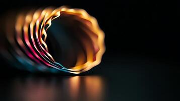 Colorful spiral of metallic rings reflecting light in a dark setting, showcasing design and texture photo