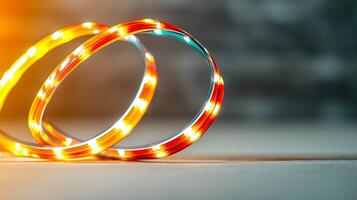 Colorful LED light strips coiled on a surface, with a blurred background creating a warm ambiance photo