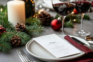 Christmas dinner table setting with menu, red wine, and festive decorations photo
