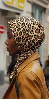 A woman wearing a leopard print scarf photo