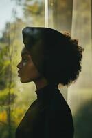Woman wearing a silk bonnet by a window in natural light photo