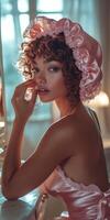 Elegant woman in silk bonnet poses in softly lit bedroom environment photo