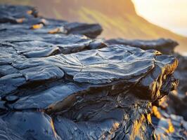Lava rock formations hint at volcanic activity during sunset near coastline photo