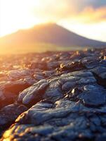 Sunset over volcanic landscape with lava formations and mountain silhouette photo