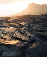 Lava formations and distant mountain at sunset near a volcano photo