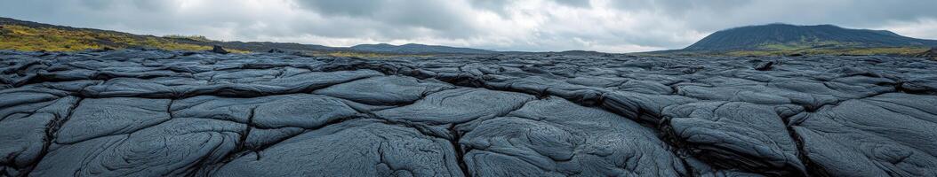 Lava landscape with hardened flow beneath overcast sky near volcanic site photo