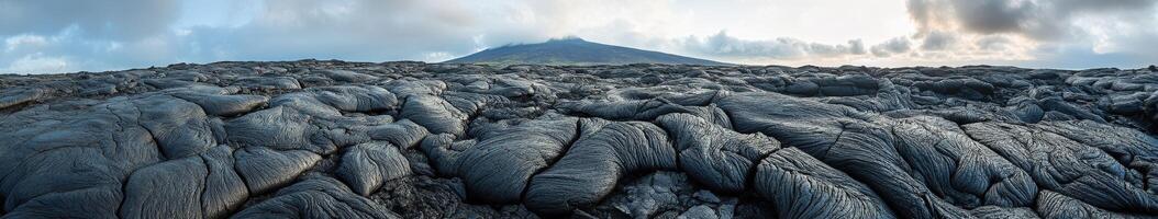 Majestic view of a volcanic landscape under a cloudy sky at dusk photo