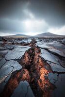 Cracked volcanic landscape revealing molten earth beneath the surface photo